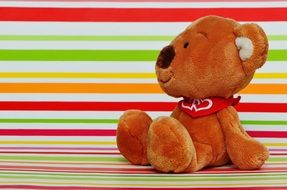 soft toy on a bright striped surface