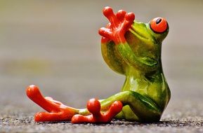 ceramic frog figure sit and look at the top