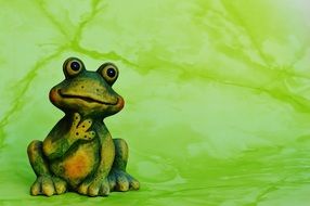 green frog on a green background