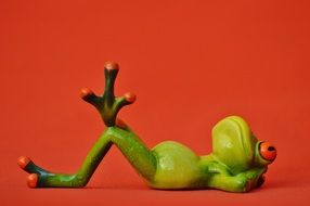 green frog on a red background