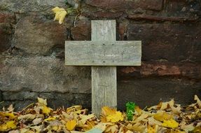 wooden cross among the dried leaves