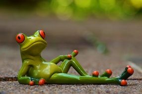 lying ceramic frog
