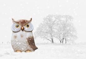 owl toy on the background of winter trees