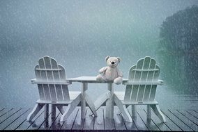 Teddy Bear on table outdoor at rainy weather