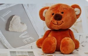 teddy bear on a background picture with the word love