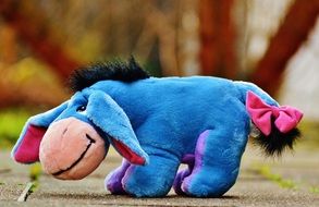 plush toy in the form of a donkey on the path in the park