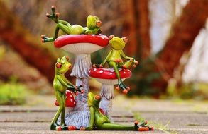 frog figurine near the fly-agaric