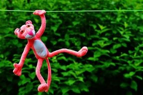 pink panther hanging on a green rope