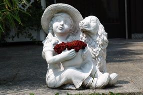 garden sculpture girl with dog