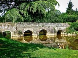 stone arch bridge over the river in ploermel