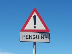 Penguins, warning traffic sign at sky, South Africa, cape point