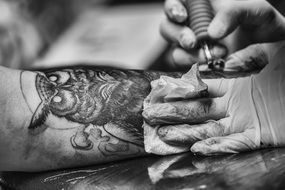 Black and white photo of making owl tatto