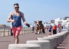 man runs along the promenade