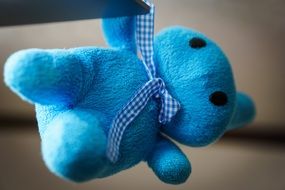 blue soft toy with bow on neck
