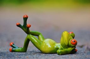 ceramic frog lies on the road