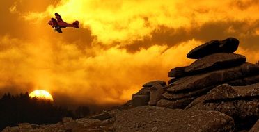 biplane soaring over mountains