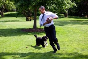 Barack obama with a family dog in the park