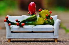 funny figure of a frog on the sofa