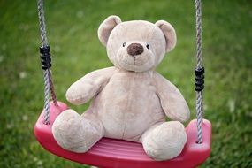 toy in the shape of a bear on a swing