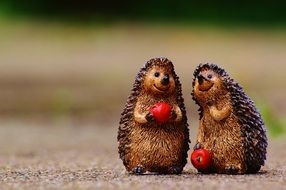 cute figures of hedgehogs with apples