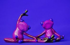 ceramic figures of a yogi frogs