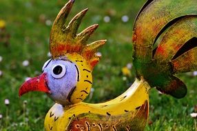 decoration in the form of a cock as a decorative element in the garden