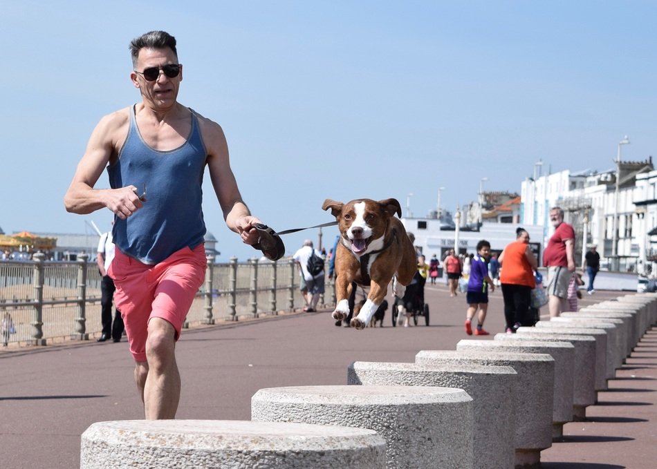 man runs along the promenade