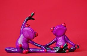 figures of two purple yogi frogs
