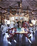 vintage carousel with wooden horses