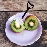 cut kiwifruit on white plate