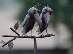 two wooden birds decorate the garden