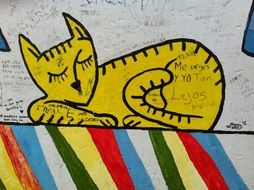 nice graffiti of yellow cat on the wall in Berlin