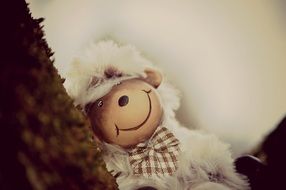 soft toy in the form of a sheep on a tree