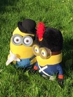 two plush minions on green grass