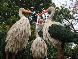 Storks and baby garden sculpture