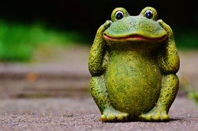 funny green garden figure of a frog