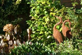 metal figures of cranes in the garden
