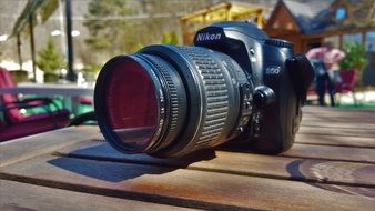 camera nikon on a wooden table