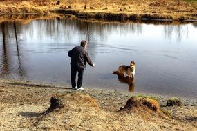 Human and doggie on a lake