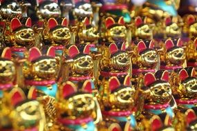 golden figures of waving cats