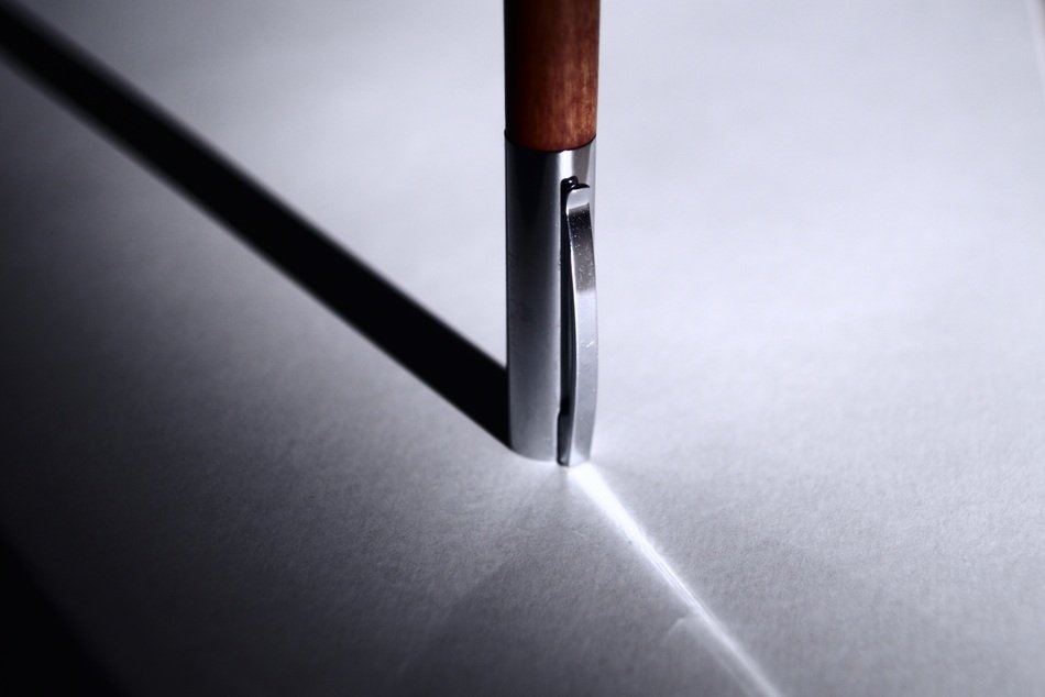 the shadow of the pen on the table