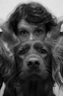portrait of a man behind an irish setter