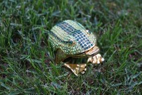 sculpture of a frog on green grass