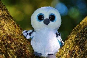 soft toy of snowy owl on the tree