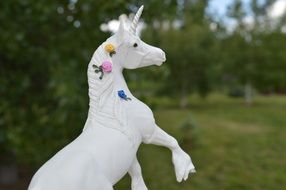 white unicorn toy in colors