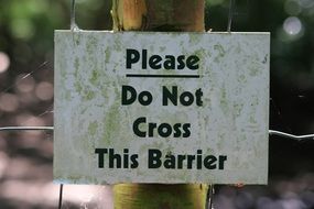 picture of the please do not cross this barrier sign