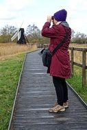 woman looking through binoculars