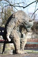 sculpture of a bear on a bench