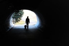 Walking with the dog in the tunnel