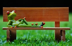 ceramic figurine frog on the bench